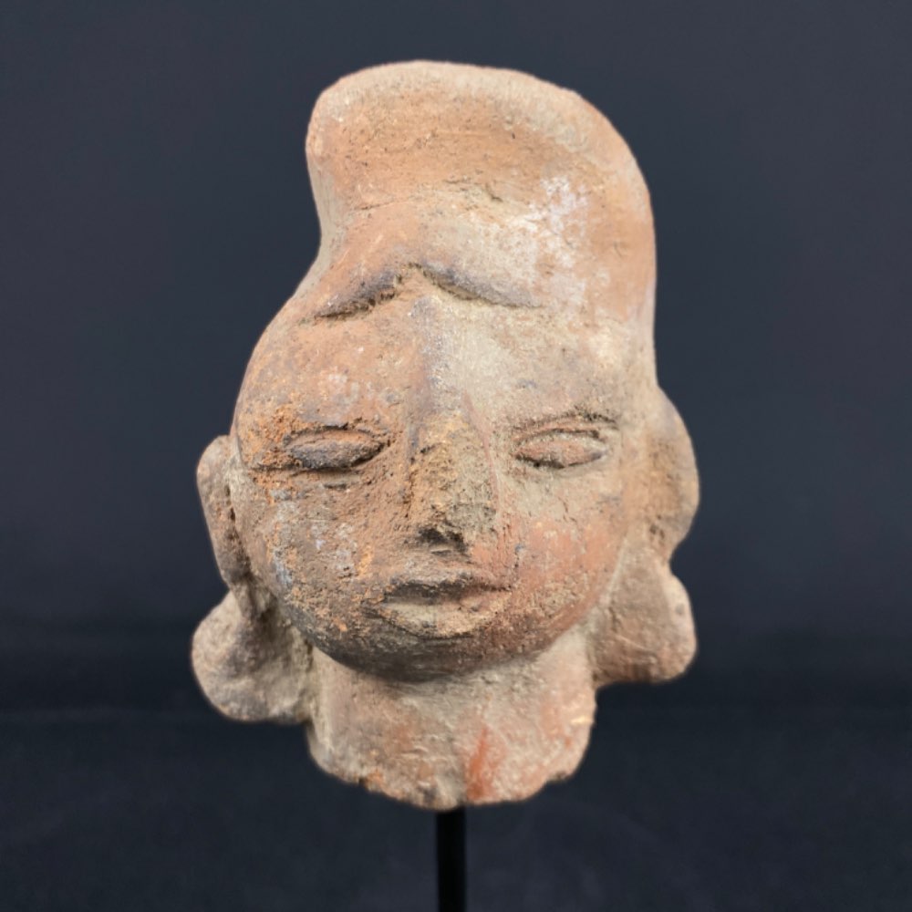 Majapahit female head with large earrings in terracotta from Indonesia